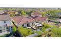 Spacious backyard with an outdoor kitchen, covered patio, and lush landscaping at 20510 W White Rock Rd, Buckeye, AZ 85396