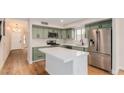 Stylish kitchen with green cabinets, stainless steel appliances, and a spacious center island at 20929 N 37Th Way, Phoenix, AZ 85050
