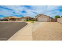 Residential street featuring well-maintained homes with desert landscaping, and two car garages at 20977 N 84Th Ln, Peoria, AZ 85382