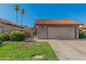 Charming single-story home featuring a well-maintained lawn, two-car garage, and clay tile roof at 2154 E Forge Ave, Mesa, AZ 85204