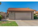 Attractive home with a tile roof, a two-car garage, and low-maintenance landscaping at 2154 E Forge Ave, Mesa, AZ 85204