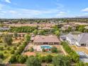 Aerial view of the backyard featuring a swimming pool with a rock waterfall and lush landscaping at 2285 E Plum St, Gilbert, AZ 85298