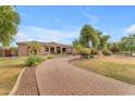 Long driveway to beautiful house with lush mature landscaping at 2285 E Plum St, Gilbert, AZ 85298