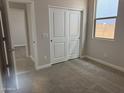 Cozy bedroom features plush carpeting, a closet and a bright window at 22895 N 183Rd Dr, Surprise, AZ 85387