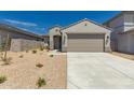 Charming single-story home with a two-car garage, desert landscaping, and a neutral color palette at 22895 N 183Rd Dr, Surprise, AZ 85387