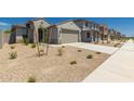 Inviting single-Gathering house showcasing desert landscaping, a well-maintained lawn, and a community street at 22895 N 183Rd Dr, Surprise, AZ 85387
