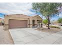 Inviting single-story home featuring a desert-landscaped yard and spacious driveway at 23613 W Mobile Ln Ln, Buckeye, AZ 85326