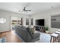 Cozy living room with sliding glass doors, ceiling fan, and comfortable seating at 2834 E Devon Ct, Gilbert, AZ 85296