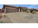 Wide driveway leading to a well-maintained home with desert landscaping in a quiet neighborhood at 34944 N Mirandesa Dr, San Tan Valley, AZ 85143