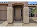 Inviting front entryway with a covered porch and decorative columns enhancing curb appeal at 34944 N Mirandesa Dr, San Tan Valley, AZ 85143