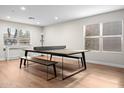 Bright game room with a ping pong table, laminate flooring, and lots of natural light from the windows at 35360 N 93Rd Way, Scottsdale, AZ 85262