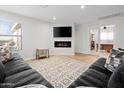 Cozy living room with modern fireplace, large sectional sofa, and neutral color palette at 35360 N 93Rd Way, Scottsdale, AZ 85262