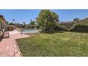 Large backyard featuring a well-maintained lawn and a fenced swimming pool, ideal for relaxation and recreation at 3924 E Cortez St, Phoenix, AZ 85028