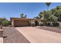 Inviting single-story home with a two-car garage, an arched doorway, and desert landscaping at 3924 E Cortez St, Phoenix, AZ 85028