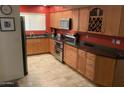 Well-lit kitchen features wooden cabinets, stainless steel appliances, and contrasting countertops at 3924 E Cortez St, Phoenix, AZ 85028