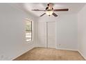 Cozy bedroom featuring neutral paint, carpet, and a window with a view of trees at 4143 E Sundance Ave, Gilbert, AZ 85297