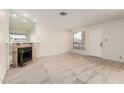 Bright living room with cozy fireplace and neutral carpet, offering a comfortable and inviting atmosphere at 420 W Yukon Dr # 8, Phoenix, AZ 85027