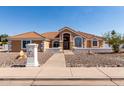 Inviting single-story home features a tiled roof, desert landscaping, and a walkway to the front door at 4622 E Ellis Cir, Mesa, AZ 85205