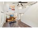 Spacious living area with high ceilings, wood floors, and an open layout to the dining area at 4759 E Woburn Ln, Cave Creek, AZ 85331