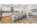 Bright kitchen boasts a large island with seating, stylish light fixtures, and stainless steel appliances at 4920 E Osborn Rd, Phoenix, AZ 85018