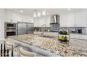 Gourmet kitchen featuring a large island with seating, granite countertops, and stainless steel appliances at 4920 E Osborn Rd, Phoenix, AZ 85018