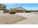 Exterior of a well-maintained home with a two-car garage and desert landscaping at 7530 E North Ln, Scottsdale, AZ 85258