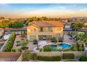 Beautiful backyard featuring a sparkling pool, mature trees, and an inviting outdoor seating area at 8500 W Nicolet Ave, Glendale, AZ 85305