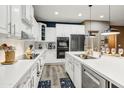 A well-equipped kitchen features white cabinets, stainless appliances, and spacious countertops at 8500 W Nicolet Ave, Glendale, AZ 85305