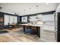 Modern kitchen features a large island, stainless steel appliances, and a breakfast bar at 8500 W Nicolet Ave, Glendale, AZ 85305