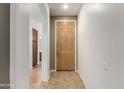 Welcoming entryway featuring neutral-toned tile flooring, an inviting front door, and arched openings to other rooms at 8848 W Cordes Rd, Tolleson, AZ 85353