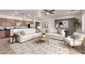 Open concept living room with couches, neutral color palette, and kitchen view at 8848 W Cordes Rd, Tolleson, AZ 85353