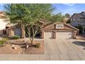 Charming home with a well-maintained lawn, desert landscaping, and a convenient three-car garage at 1015 E Constitution Dr, Gilbert, AZ 85296