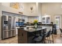 Stylish kitchen with stainless steel appliances, granite countertops, an island with bar seating at 1015 E Constitution Dr, Gilbert, AZ 85296