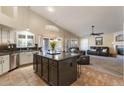 Open-concept kitchen featuring a center island, modern appliances, and seamless transition into the living area at 1015 E Constitution Dr, Gilbert, AZ 85296