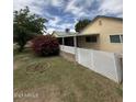 Spacious backyard with a covered patio area, fence, and lush landscaping at 10201 N 97Th Ave # B, Peoria, AZ 85345