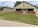 Charming single-story home with a brick accent wall and a well-manicured front lawn at 10201 N 97Th Ave # B, Peoria, AZ 85345