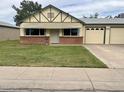 Charming single-story home with a brick accent wall and a well-manicured front lawn at 10201 N 97Th Ave # B, Peoria, AZ 85345