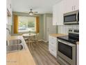 Bright kitchen featuring stainless steel appliances, butcher block countertops, and eat in dining area at 10201 N 97Th Ave # B, Peoria, AZ 85345