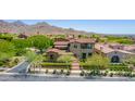 Stunning view of the home with a tile roof nestled in the desert landscape and mountain views at 10287 E Diamond Rim Dr, Scottsdale, AZ 85255