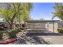 Inviting front exterior showcasing a covered carport and manicured landscaping, offering curb appeal at 1050 S Stapley Dr # 62, Mesa, AZ 85204
