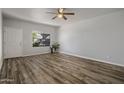 Open living room featuring luxury vinyl plank flooring, ceiling fan and large window offering great natural light at 1050 S Stapley Dr # 62, Mesa, AZ 85204