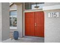 Close-up of the double front door with sidelight windows under a hanging light fixture and house number at 115 W El Freda Rd, Tempe, AZ 85284