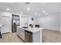 Contemporary kitchen with island, stainless steel appliances and tile floors at 11574 W Luxton Ln, Avondale, AZ 85323