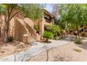 Beautiful stucco condo with mature shade trees and lush landscaping around the sidewalks at 1351 N Pleasant Dr # 2051, Chandler, AZ 85225