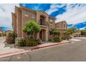 Inviting two-story home with balcony complemented by mature landscaping and flowers at 1367 S Country Club Dr # 1327, Mesa, AZ 85210