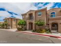 Attractive two-story home with balcony, mature trees, and colorful flower beds at 1367 S Country Club Dr # 1327, Mesa, AZ 85210