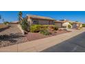 View of the house with desert landscaping, tile roof, and an attached two-car garage at 14390 W Morning Star Trl, Surprise, AZ 85374