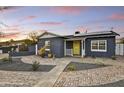 Attractive house with solar panels, nice front yard, and cheerful yellow door at 1444 E Coronado Rd, Phoenix, AZ 85006