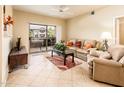 Comfortable living room with a plush sofa, balcony access, and ample natural light at 14950 W Mountain View Blvd # 7209, Surprise, AZ 85374