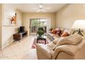 Cozy living room features a sliding glass door that brings in natural light and fresh air at 14950 W Mountain View Blvd # 7209, Surprise, AZ 85374